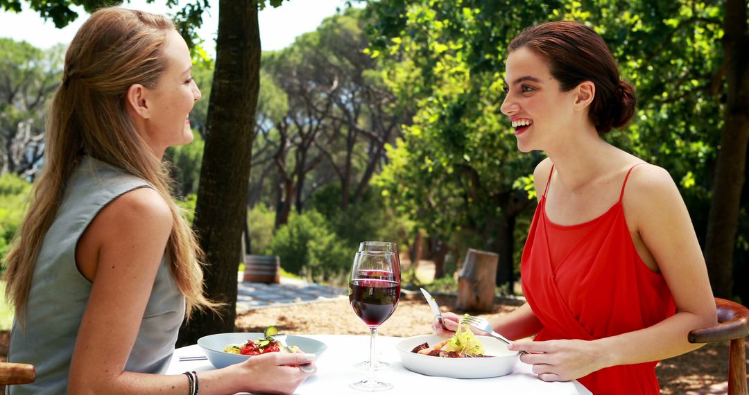 Two Women Enjoying Outdoor Lunch at Forest Restaurant Table - Free Images, Stock Photos and Pictures on Pikwizard.com