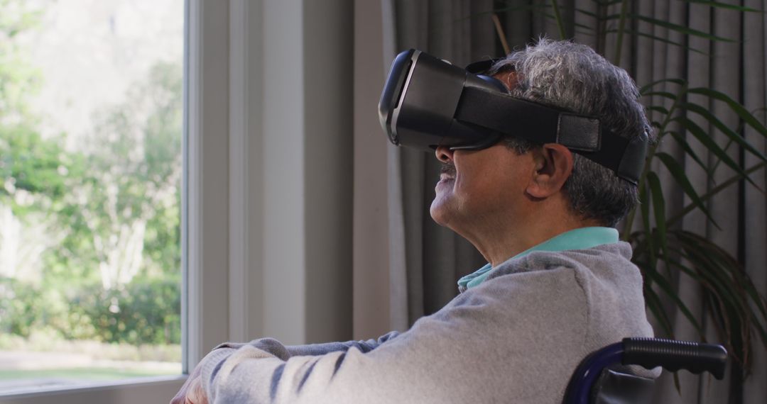 Elderly Man Using Virtual Reality Headset By Window Light - Free Images, Stock Photos and Pictures on Pikwizard.com