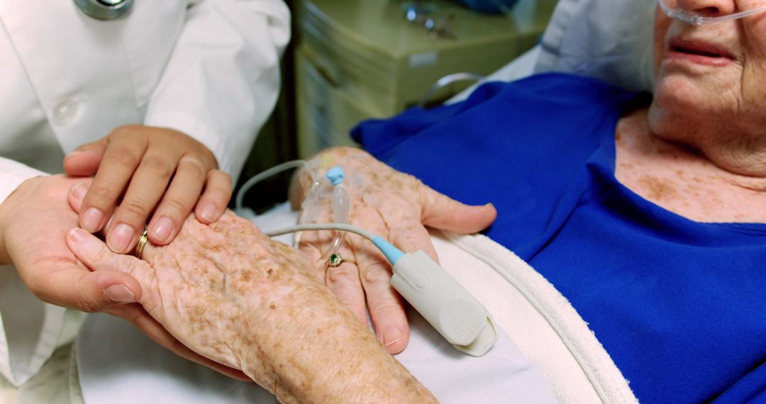 Doctor Holding Elderly Woman's Hand in Hospital - Free Images, Stock Photos and Pictures on Pikwizard.com