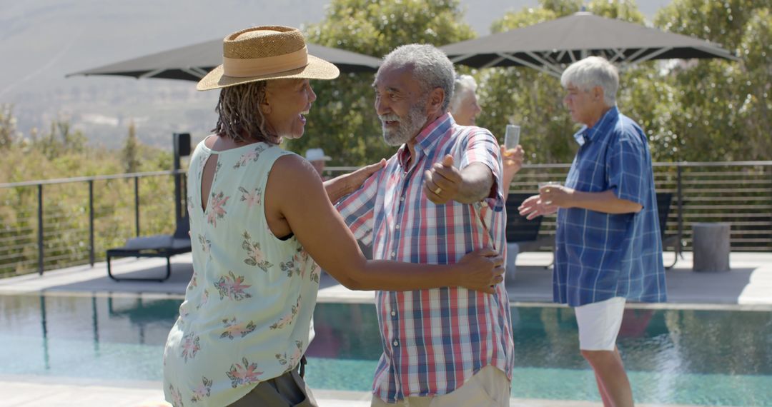 Senior Couple Embracing by Poolside with Friends - Free Images, Stock Photos and Pictures on Pikwizard.com