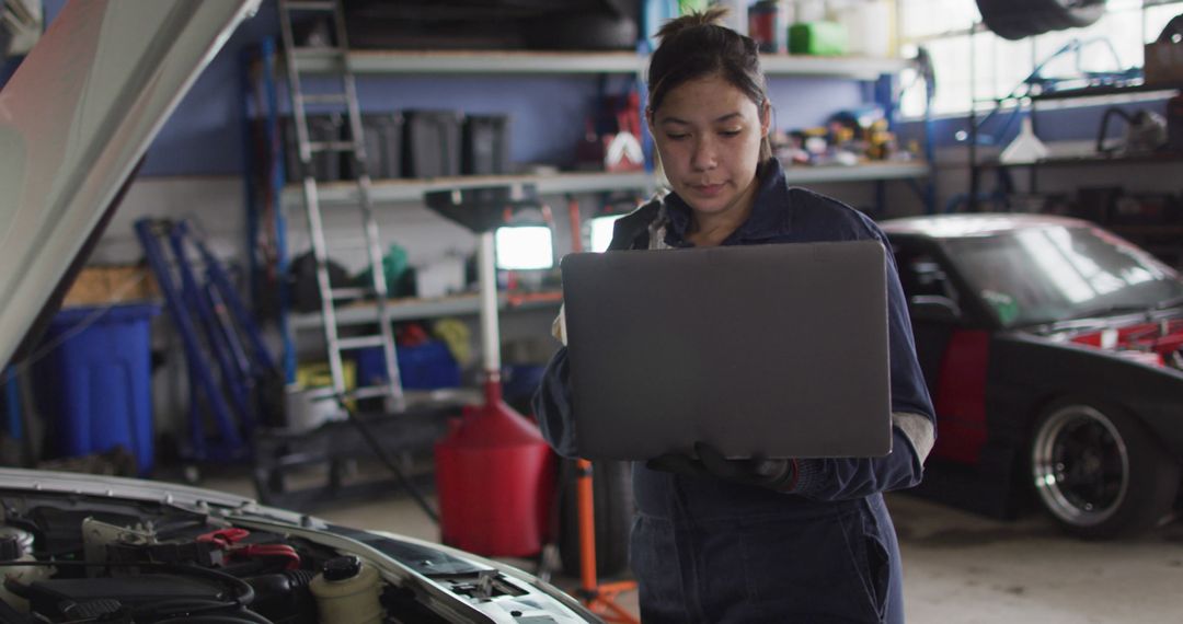 Female Mechanic Working in Auto Shop with Laptop in Hand - Free Images, Stock Photos and Pictures on Pikwizard.com