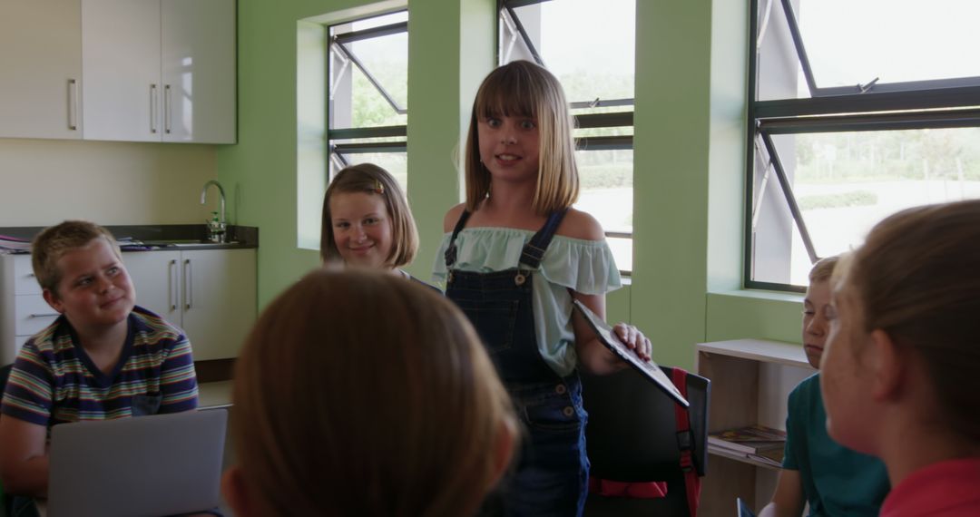 Young Girl Giving Presentation in Classroom to Attentive Peers - Free Images, Stock Photos and Pictures on Pikwizard.com