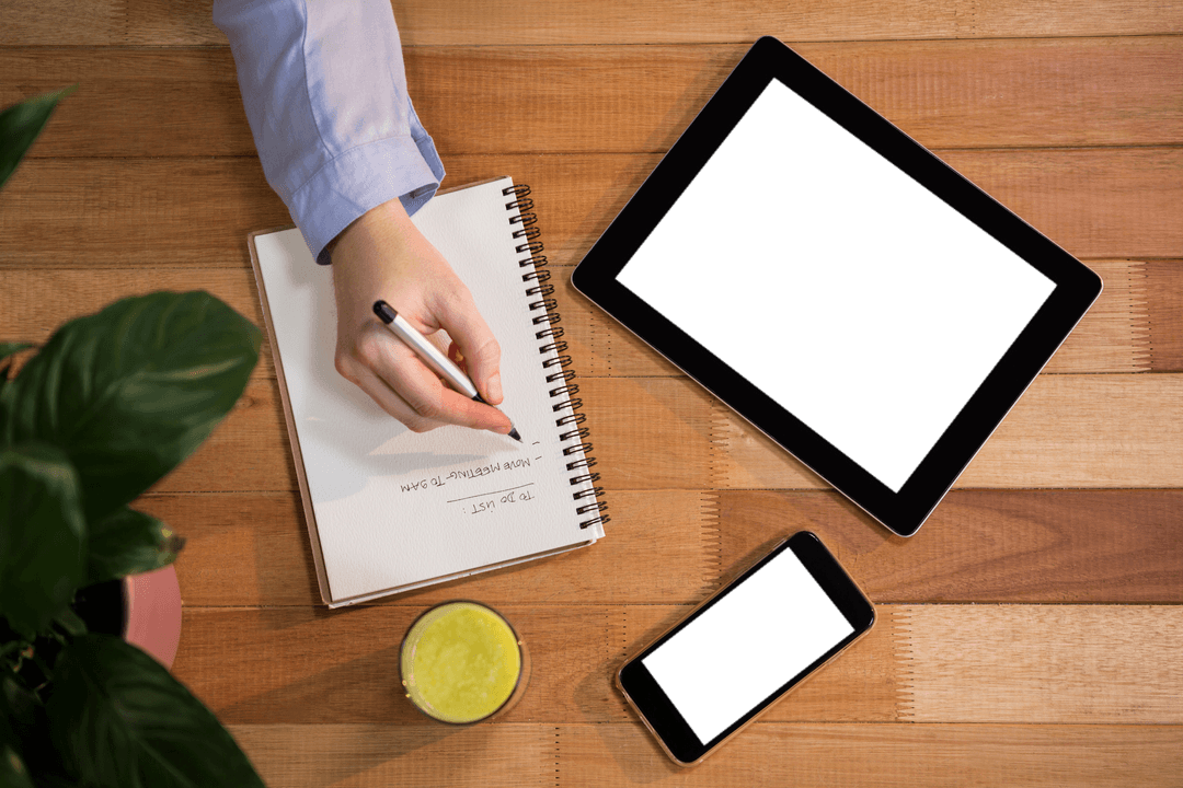 Transparent Planner Note Taking with Tech Gadgets on Wood Desk