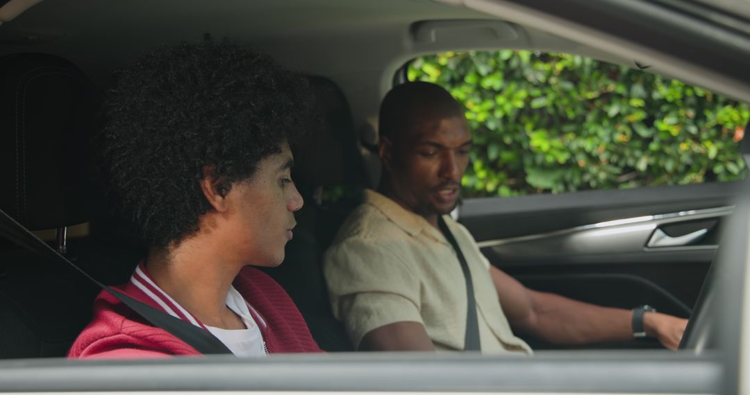 Father and Son Bonding While Seated in Car, Emphasizing Safety