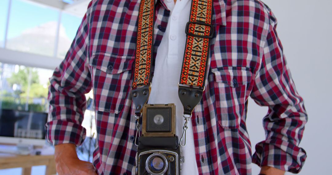 Caucasian man stands with a vintage camera, with copy space - Free Images, Stock Photos and Pictures on Pikwizard.com
