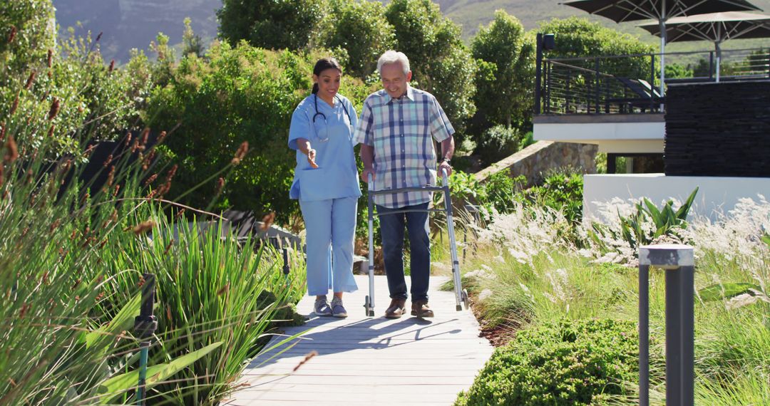 Senior man walking with nurse using walker in garden - Free Images, Stock Photos and Pictures on Pikwizard.com