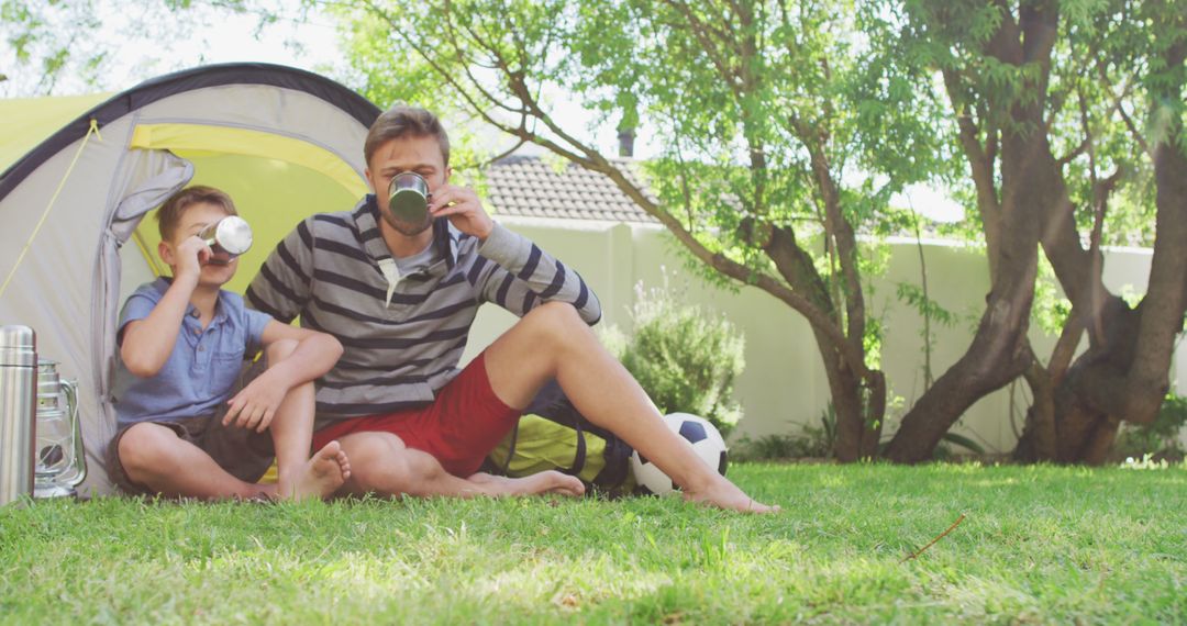 Father and Son Camping in Backyard Drinking Morning Coffee - Free Images, Stock Photos and Pictures on Pikwizard.com