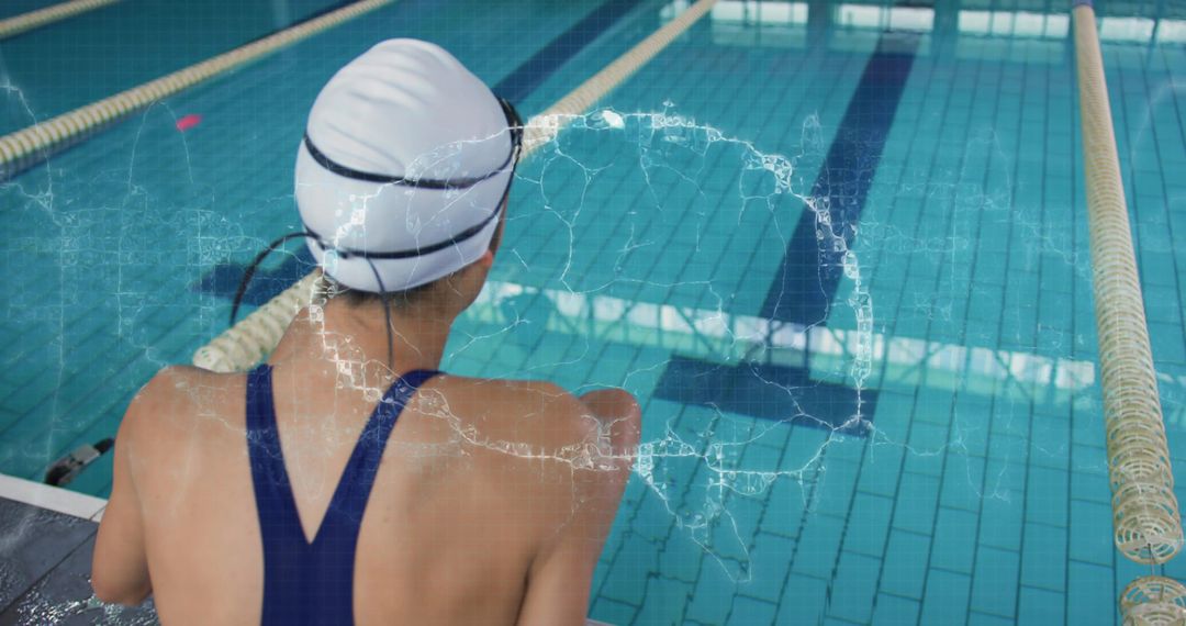 Female Competitive Swimmer Leaning at Pool Edge Wearing White Swim Cap and Navy Suit Preparing for L