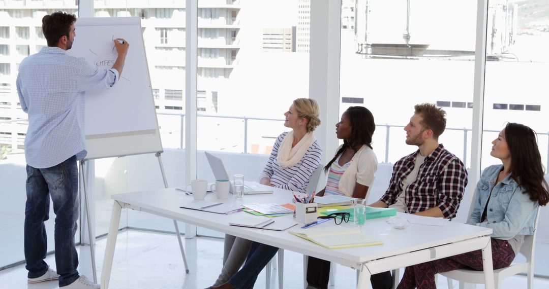 Creative Designer Presenting Ideas to Team in Modern Office