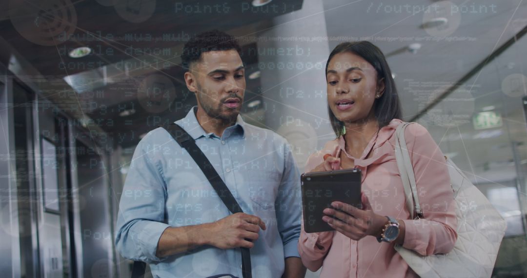 Coworkers Reviewing Financial Data on Tablet in Modern Office