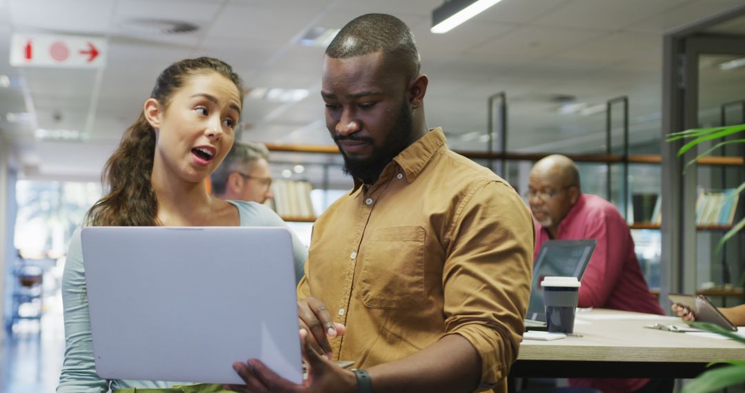 Colleagues Collaborating on Project in Modern Office Setting