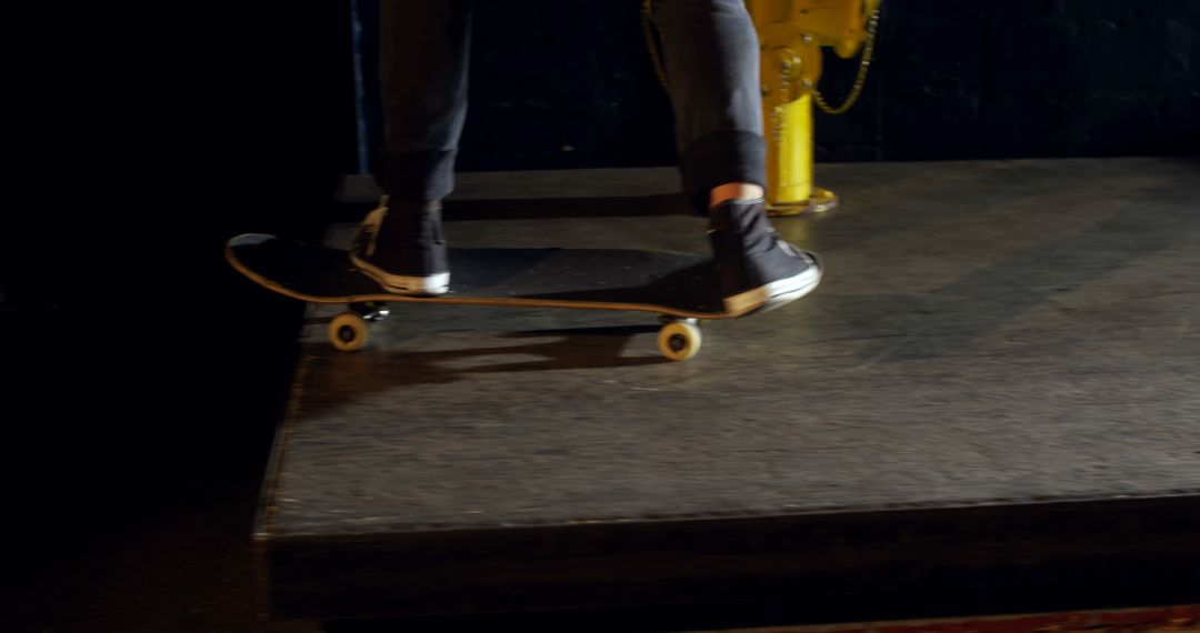 Close-Up of Skateboarder on Dark Indoors Skate Park - Free Images, Stock Photos and Pictures on Pikwizard.com