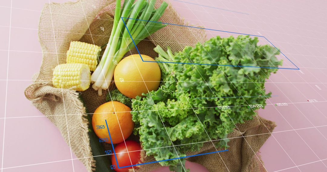 Fresh Produce Burlap Sack with Kale, Oranges, Corn and Wireframe Grid on Pink Table