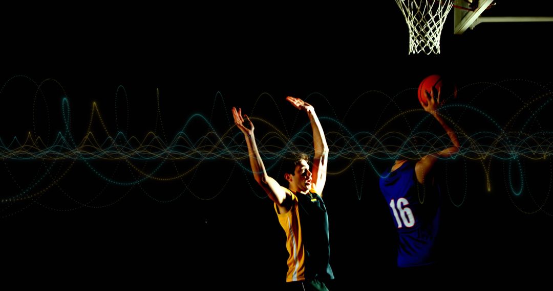 Basketball Players in Intense Competition Under Bright Hoop