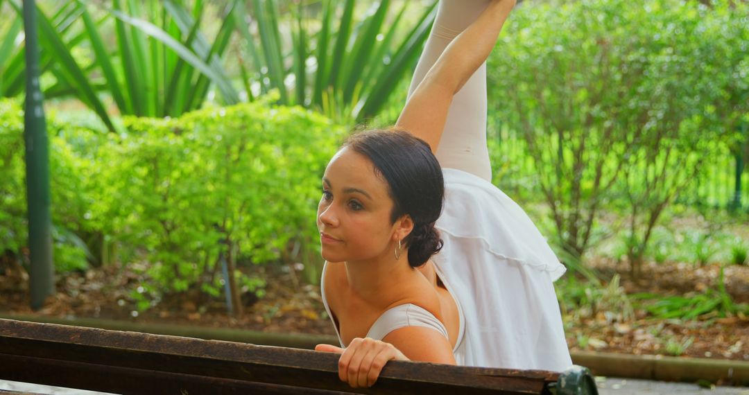 Ballet Dancer Stretching on Park Bench in Outdoor Setting - Free Images, Stock Photos and Pictures on Pikwizard.com