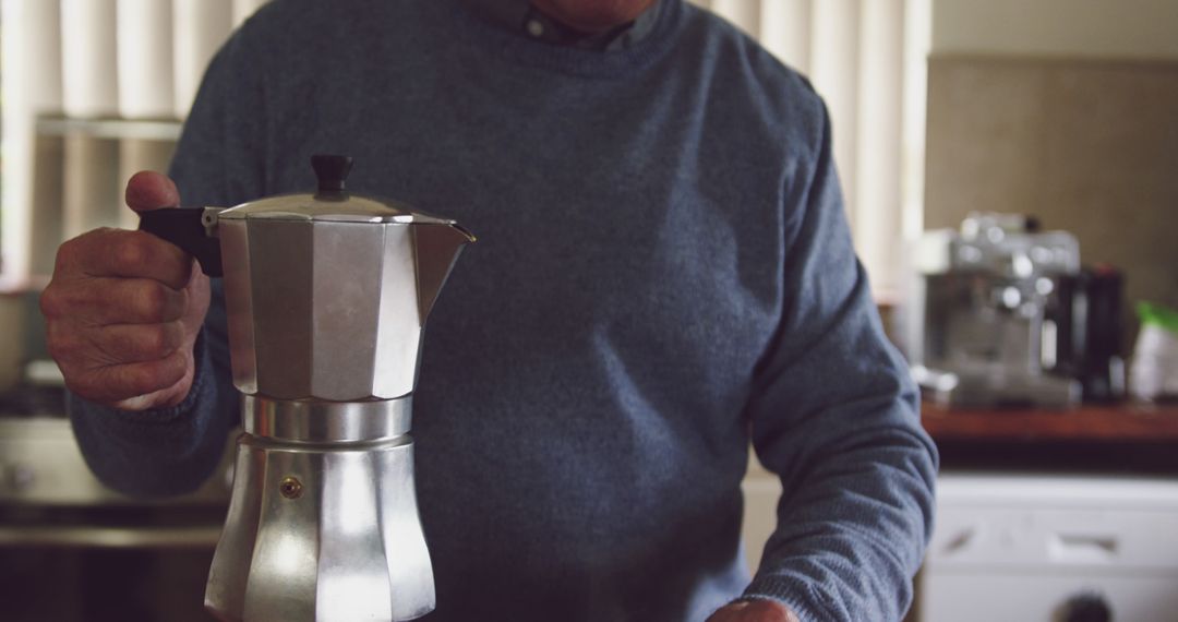 Senior Man Holding Moka Pot in Cozy Kitchen - Free Images, Stock Photos and Pictures on Pikwizard.com