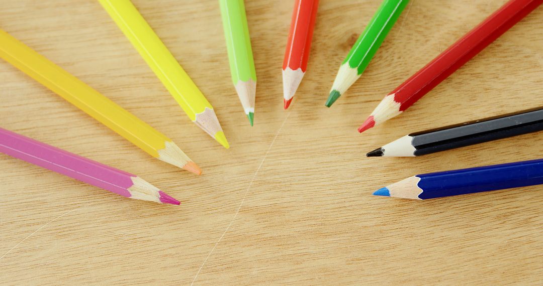 Colored pencils are arranged in a semi-circle on a wooden surface, with copy space - Free Images, Stock Photos and Pictures on Pikwizard.com