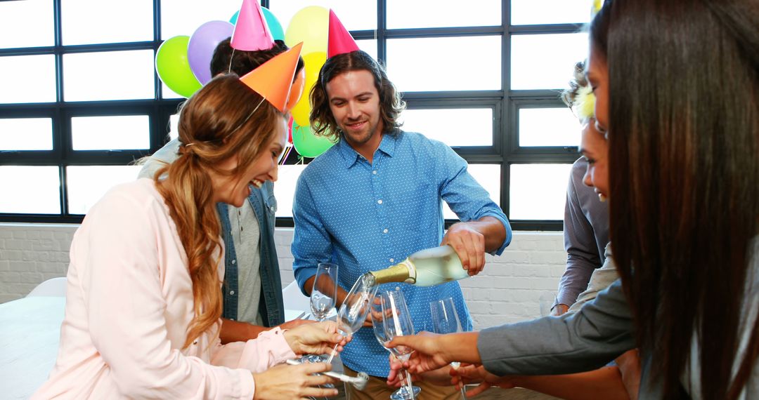 Colleagues Enjoying Office Celebration with Wine and Balloons - Free Images, Stock Photos and Pictures on Pikwizard.com