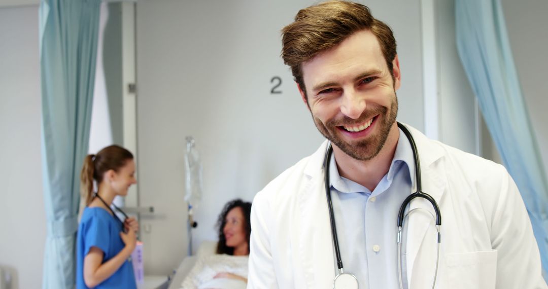 Smiling Male Doctor with Stethoscope in Hospital Room - Free Images, Stock Photos and Pictures on Pikwizard.com