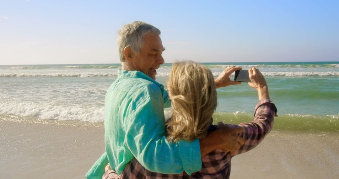 Senior Couple Taking Selfie on Beach Enjoying Time