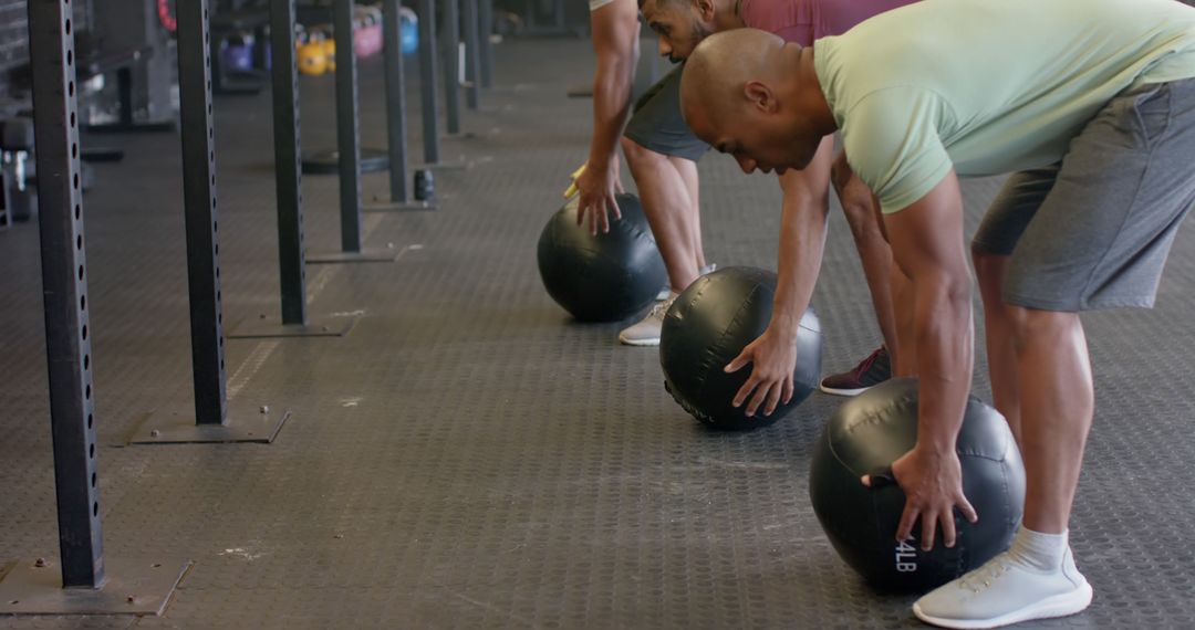 Men Preparing for CrossFit Exercise with Medicine Balls in Gym - Free Images, Stock Photos and Pictures on Pikwizard.com