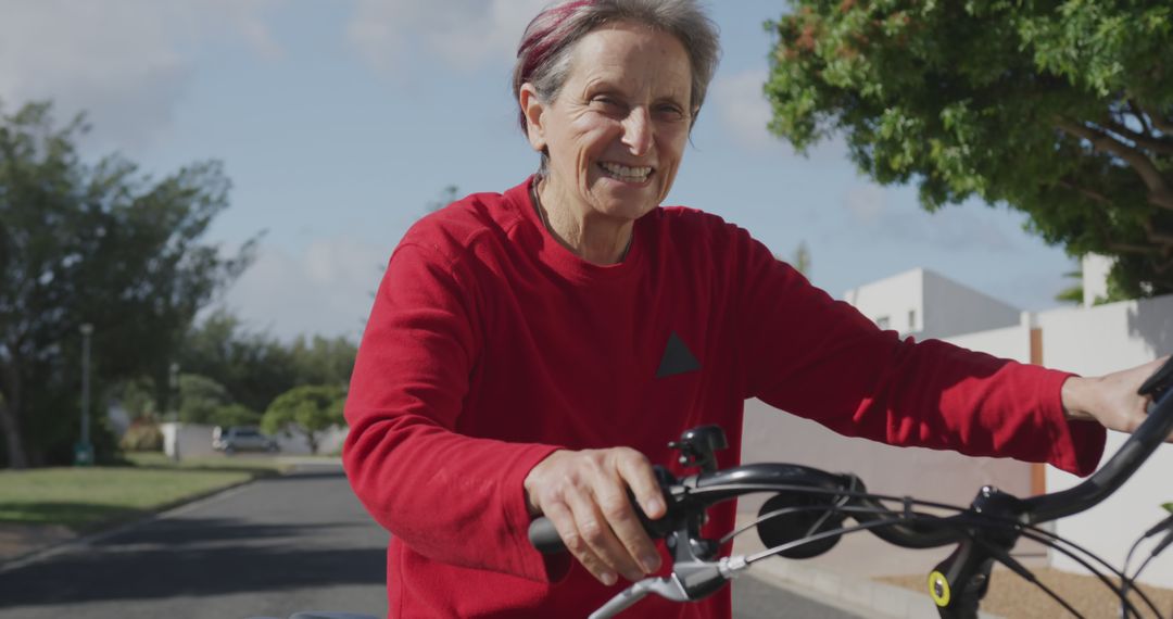 Senior Woman Enjoying a Bike Ride in the Neighborhood - Free Images, Stock Photos and Pictures on Pikwizard.com