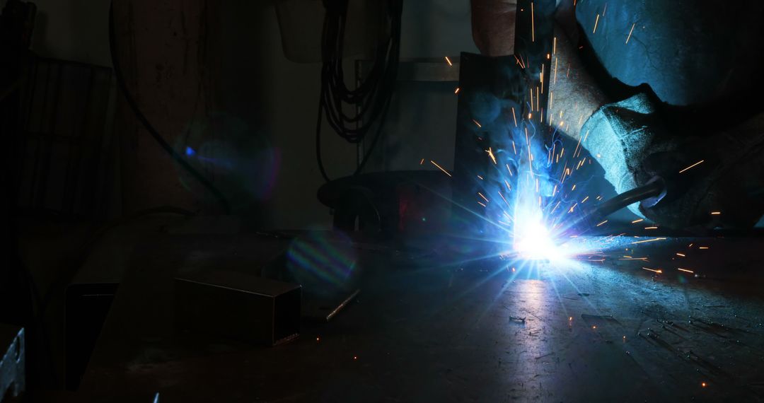 Welder Working with Bright Sparks in Metal Workshop - Free Images, Stock Photos and Pictures on Pikwizard.com