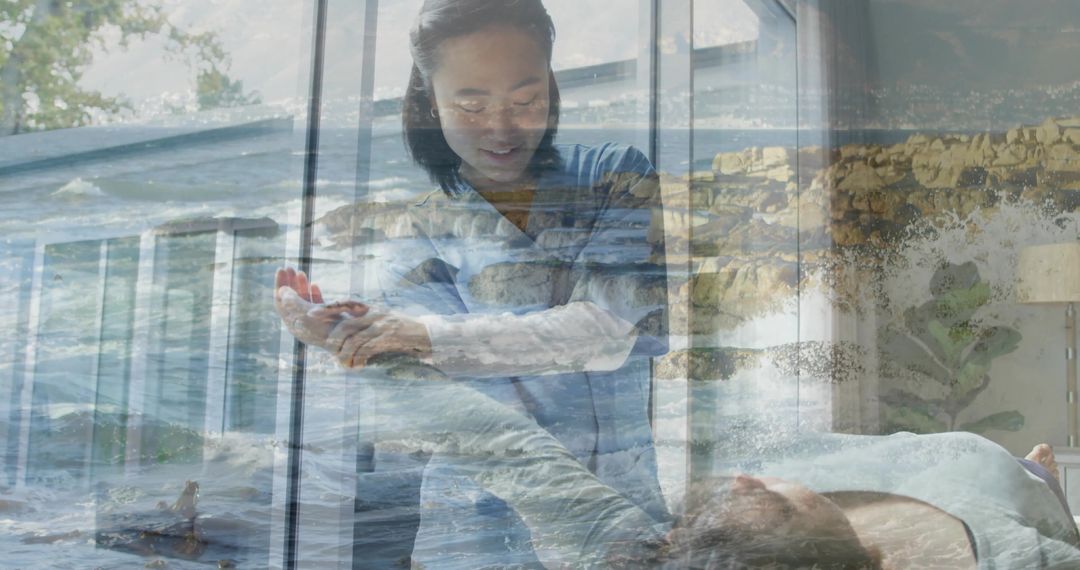 Caregiver guiding patient arm at bedside with ocean double exposure evoking healing calm