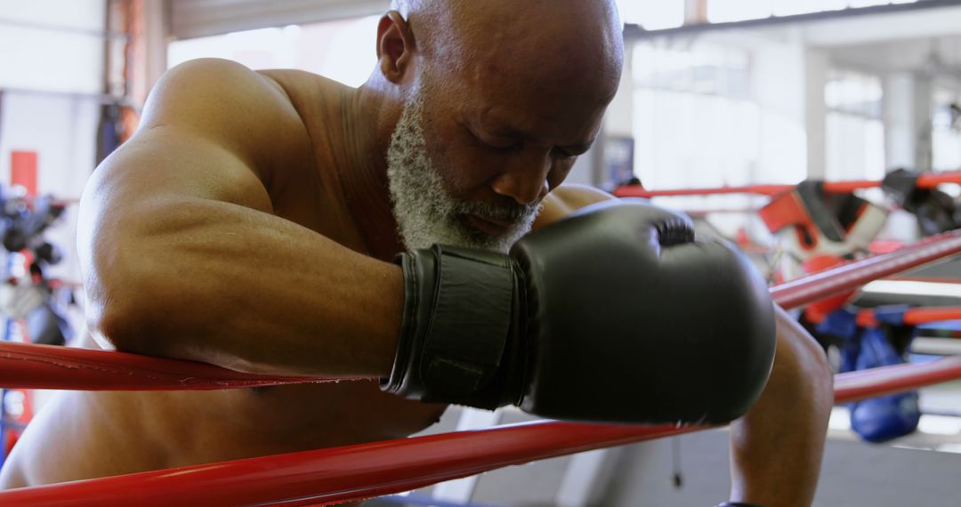 Senior Boxer Resting on Ropes in Gym - Free Images, Stock Photos and Pictures on Pikwizard.com