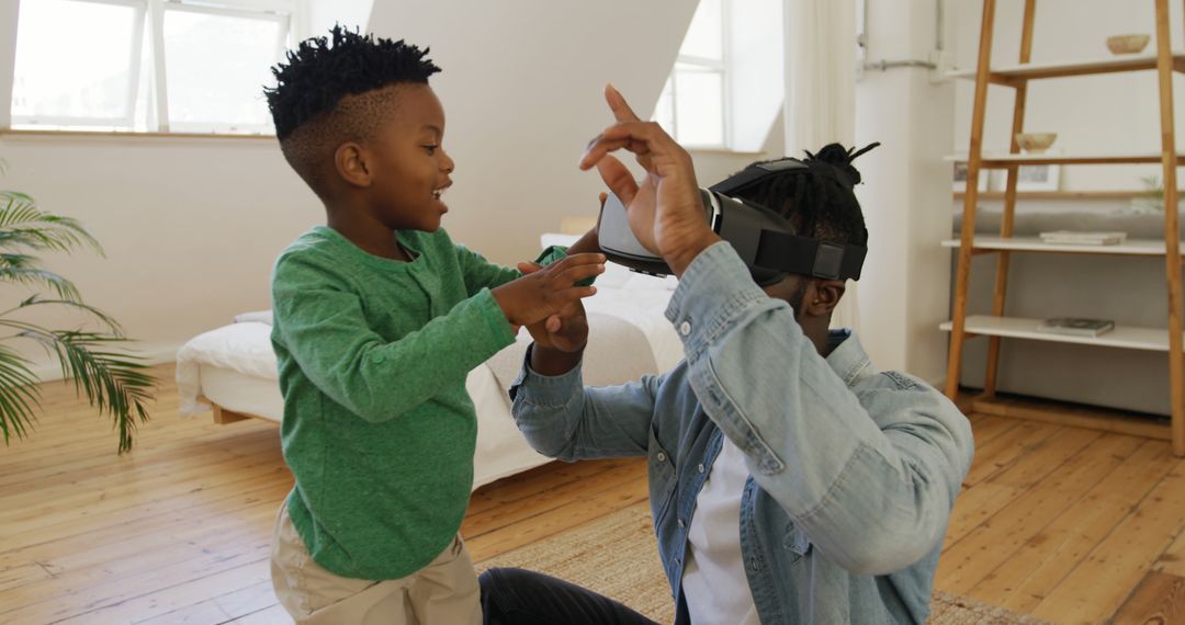 Father and Son Playing with Virtual Reality Headset in Bedroom - Free Images, Stock Photos and Pictures on Pikwizard.com