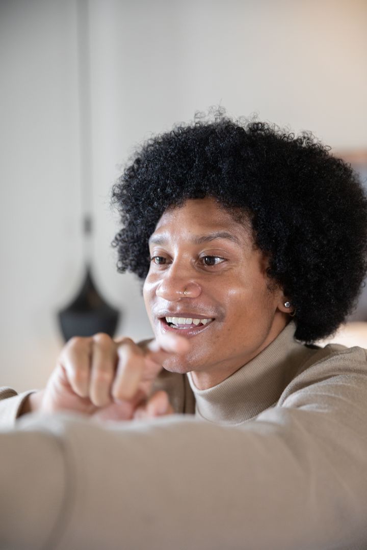 African American Man Leaning Forward in Home Office Environment