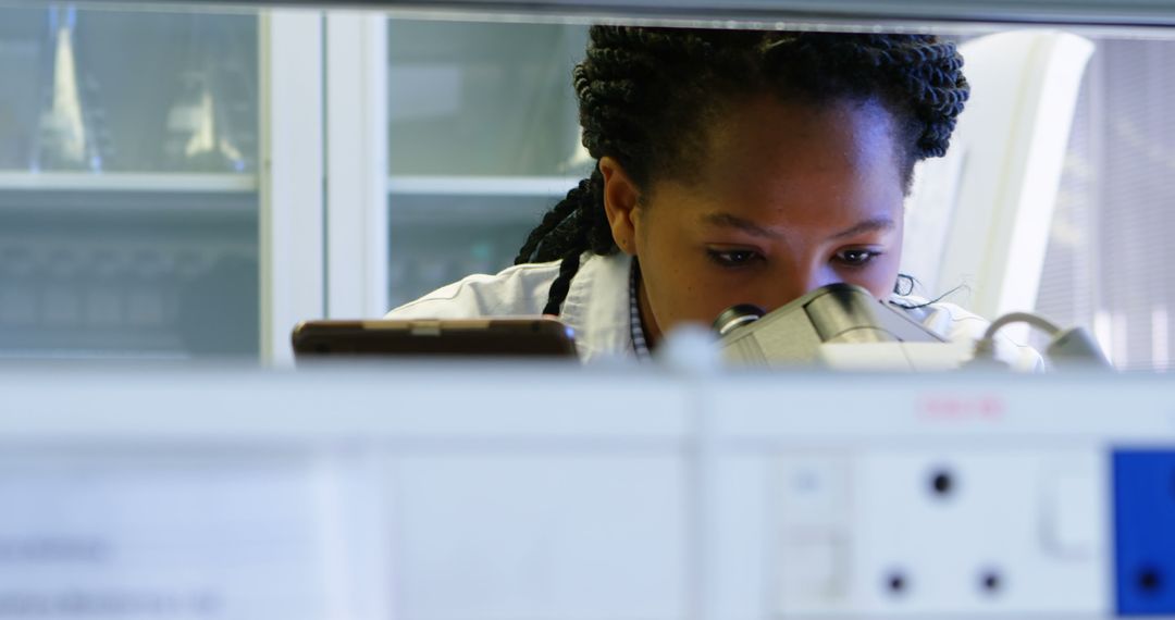 Focused Female Scientist Using Microscope in Laboratory - Free Images, Stock Photos and Pictures on Pikwizard.com