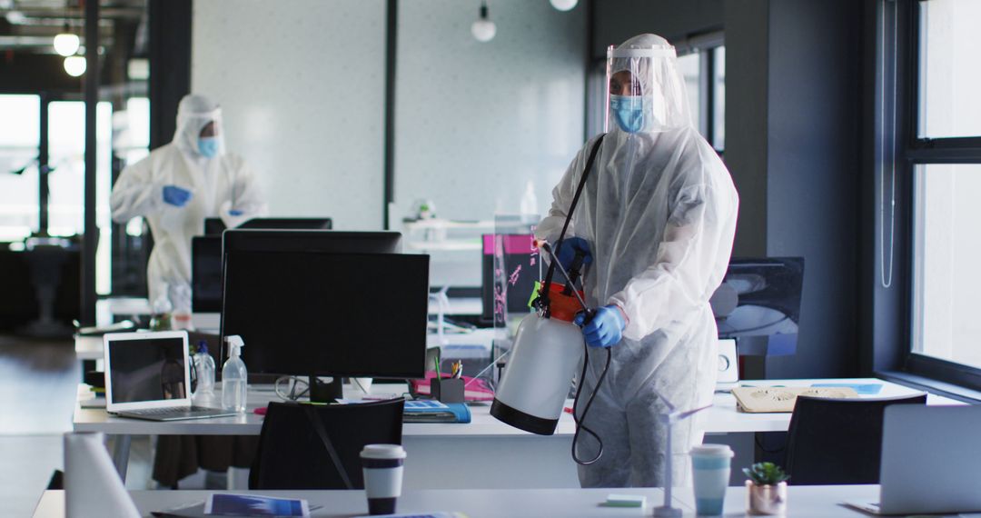 Cleaning Crew Disinfecting Office Workspace in Protective Suits - Free Images, Stock Photos and Pictures on Pikwizard.com