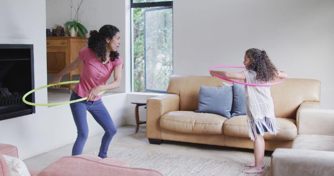 Mother and Daughter Playing with Hula Hoops Indoors - Free Images, Stock Photos and Pictures on Pikwizard.com