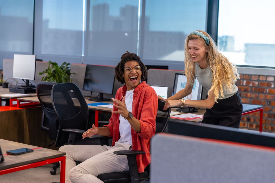 Diverse Coworkers Enjoy Relaxed Moment in Open-Plan Office