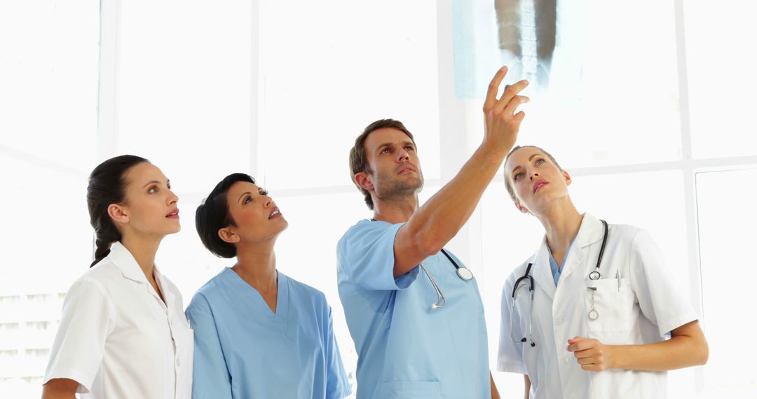 Team of Medical Professionals Analyzing X-Ray in Hospital - Free Images, Stock Photos and Pictures on Pikwizard.com