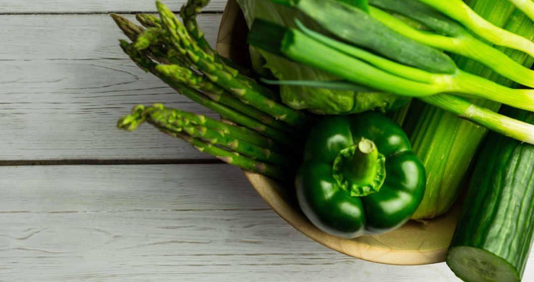 Assorted Fresh Green Vegetables on Wooden Surface