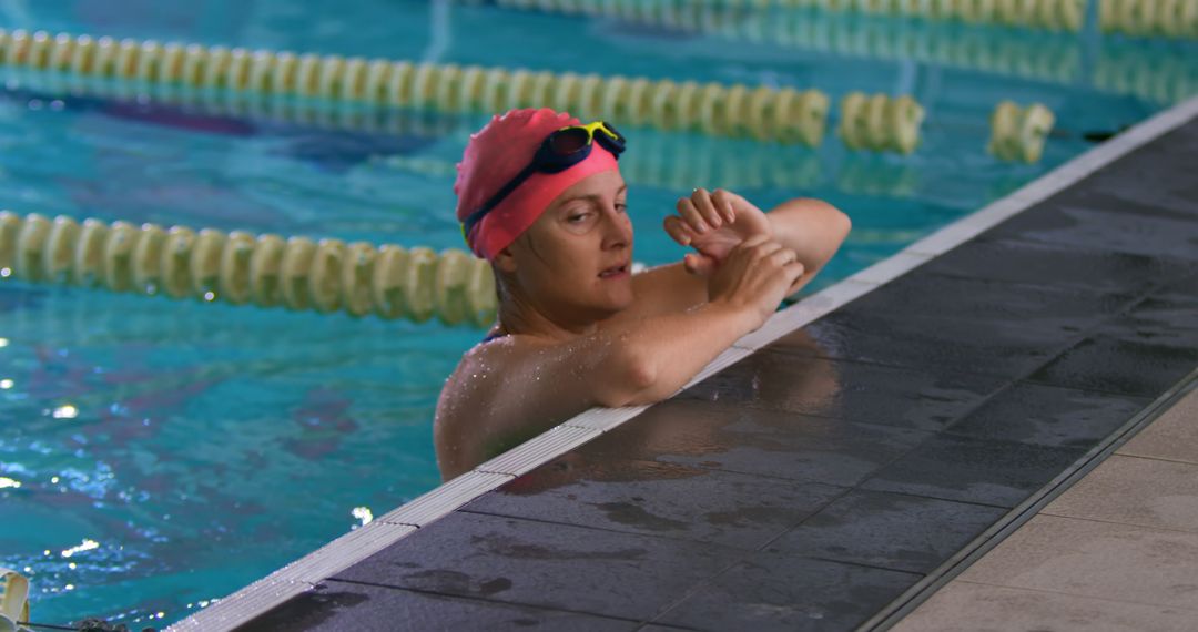 Woman Swimmer Checking Smartwatch by Poolside - Free Images, Stock Photos and Pictures on Pikwizard.com