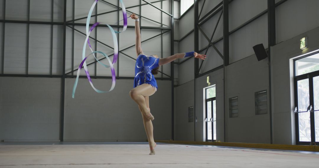 Female Gymnast Performing Ribbon Routine in Sports Hall - Free Images, Stock Photos and Pictures on Pikwizard.com