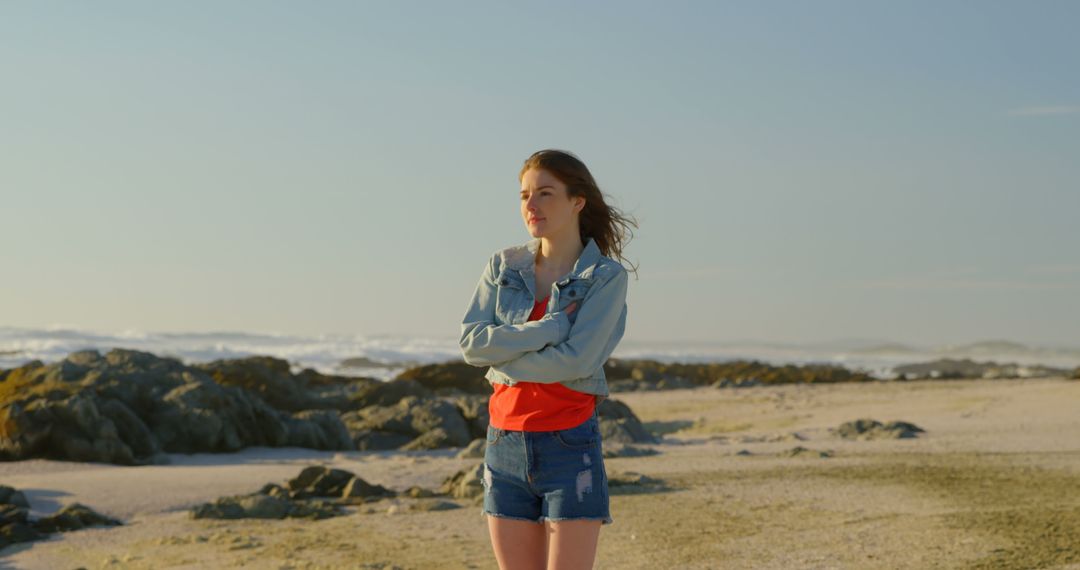 Young Woman Standing Confidently on Sandy Beach in Casual Summer Outfit - Free Images, Stock Photos and Pictures on Pikwizard.com