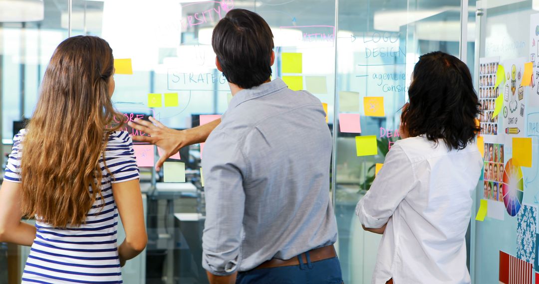 Team Collaborating Using Sticky Notes in Modern Office