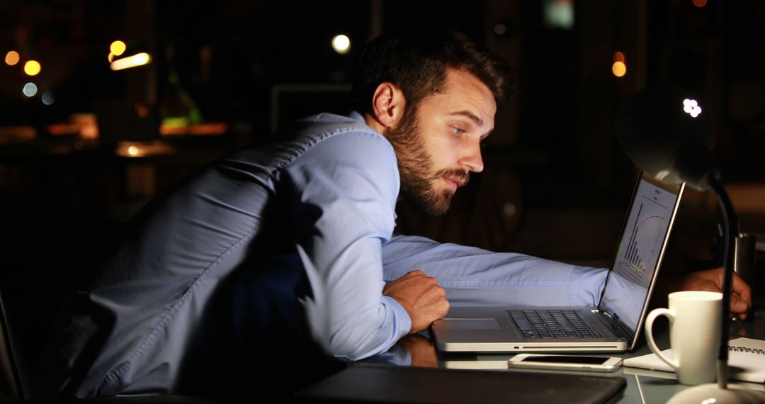 Businessman Working Late at Night in Office with Laptop - Free Images, Stock Photos and Pictures on Pikwizard.com