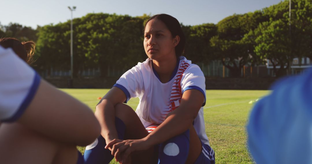 Female Soccer Player Sitting on Field - Free Images, Stock Photos and Pictures on Pikwizard.com