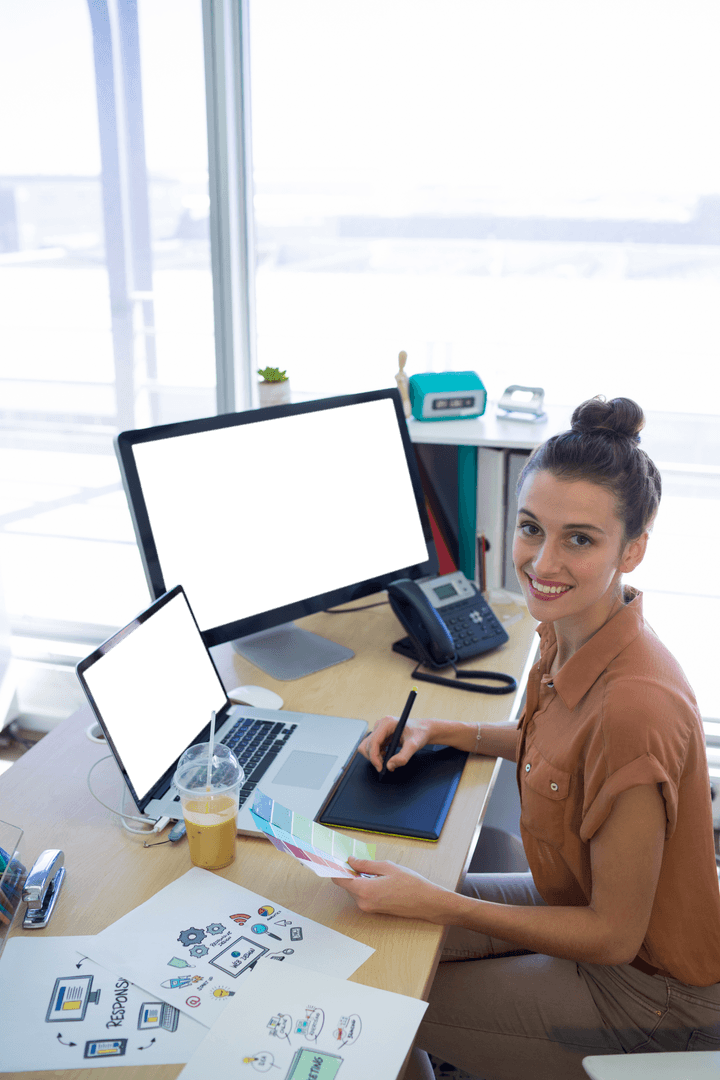 Confident Woman Designer Using Graphic Tablet at Transparent Office Desk