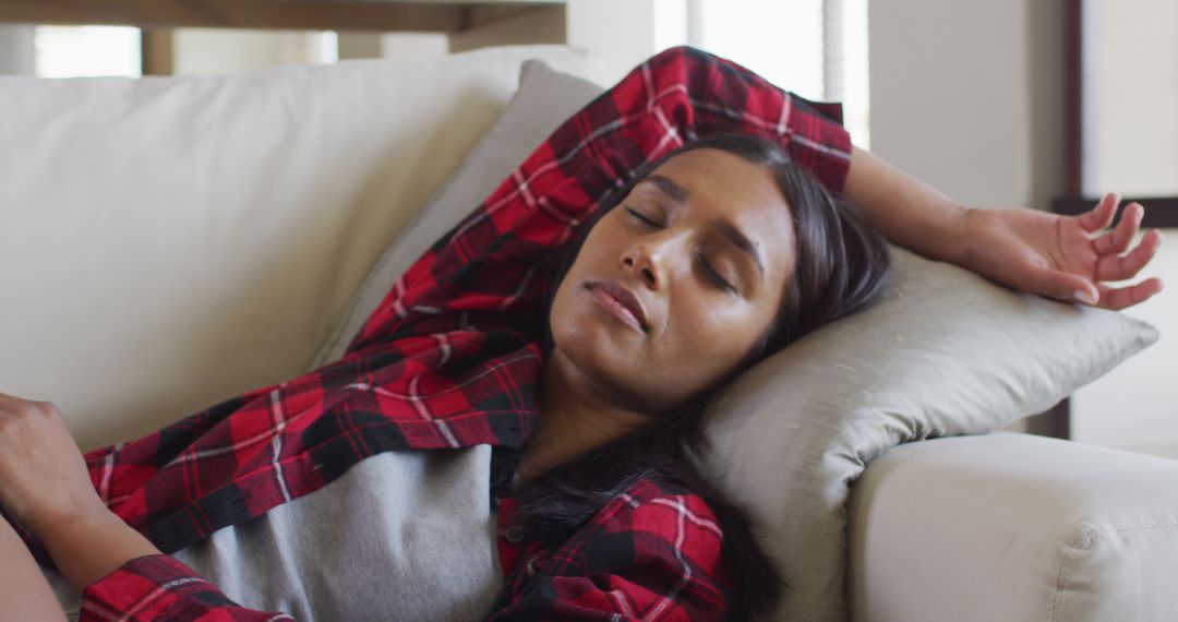 Young Woman Napping on Couch in Flannel Shirt - Free Images, Stock Photos and Pictures on Pikwizard.com