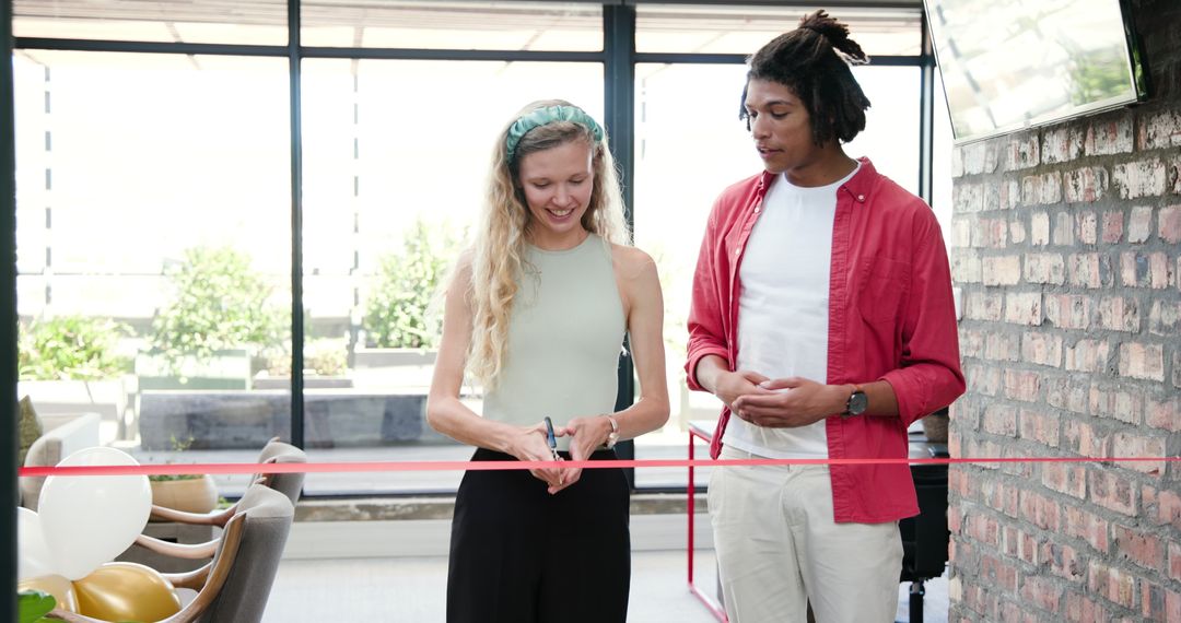 Smiling Colleagues Celebrating with Ribbon and Balloons in Office Event