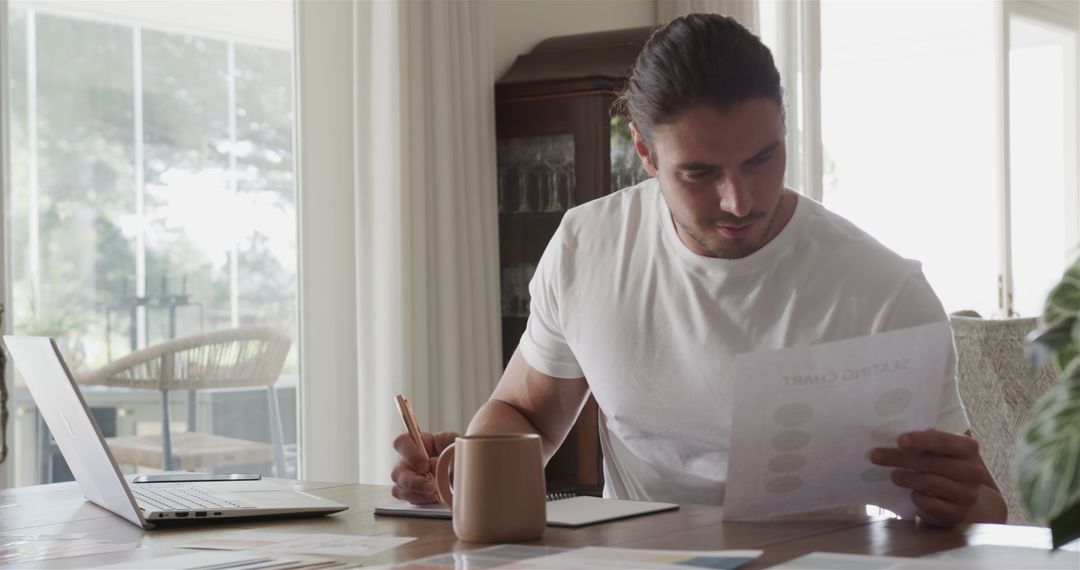 Man Focusing on Work at Home Office with Coffee and Laptop