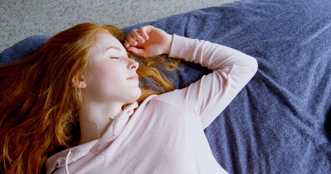 Young Woman Relaxing Peacefully on Sofa - Free Images, Stock Photos and Pictures on Pikwizard.com