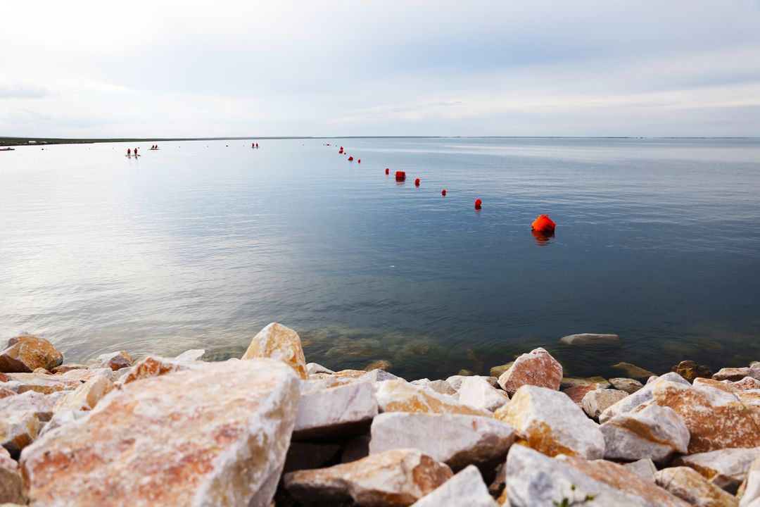 Serene Seaside with Calm Waters and Rock Shoreline - Free Images, Stock Photos and Pictures on Pikwizard.com