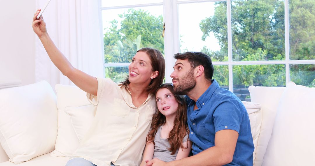 Happy Family Taking Selfie on Couch in Bright Living Room - Free Images, Stock Photos and Pictures on Pikwizard.com